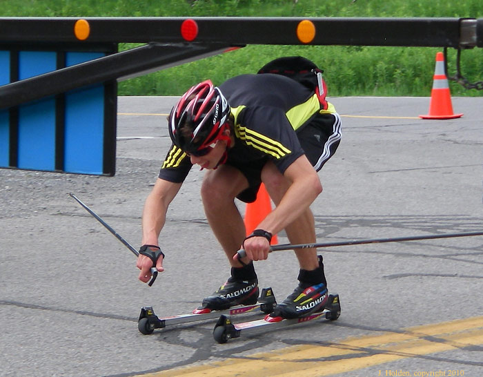Skier ducks under the gate