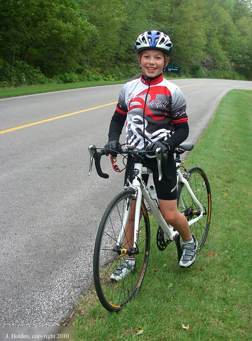 Cyclist Antoine at the top of the Black Lake Hill
